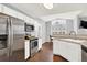 Bright kitchen with stainless steel appliances, white cabinets, and a dining area at 7440 S Blackhawk St # 16-208, Englewood, CO 80112