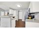 Functional kitchen featuring white cabinetry, a breakfast bar, and modern appliances at 7440 S Blackhawk St # 16-208, Englewood, CO 80112