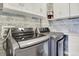 Laundry area with front-load washer and dryer and upper cabinets for storage at 7440 S Blackhawk St # 16-208, Englewood, CO 80112