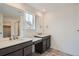 Bathroom featuring double sinks, elegant fixtures, and a glass shower at 98 Wooten Ave, Brighton, CO 80601