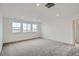 Spacious bedroom with plush carpeting and multiple windows at 98 Wooten Ave, Brighton, CO 80601