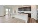 Well-lit open concept kitchen with stainless appliances and a kitchen island at 98 Wooten Ave, Brighton, CO 80601