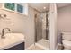 Contemporary bathroom showcases a glass-enclosed shower and modern vanity at 2531 S Hoyt Ct, Lakewood, CO 80227