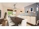 Elegant dining room features stylish lighting, table and outdoor access at 2531 S Hoyt Ct, Lakewood, CO 80227