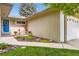 Inviting front entrance with a blue door, charming outdoor furniture, and manicured landscaping at 2531 S Hoyt Ct, Lakewood, CO 80227