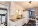 Well-designed kitchen with granite counters, white cabinetry, and ample storage at 2531 S Hoyt Ct, Lakewood, CO 80227