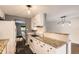 Bright kitchen boasts granite countertops, white cabinetry, and modern appliances at 2531 S Hoyt Ct, Lakewood, CO 80227
