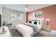 This is a comfy main bedroom with modern decor, a ceiling fan, a large window, and an accent wall at 2531 S Hoyt Ct, Lakewood, CO 80227