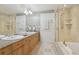Elegant bathroom featuring double vanities, soaking tub, glass-enclosed shower, and modern fixtures at 1827 N Grant St # 502, Denver, CO 80203
