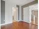 Room featuring hardwood floors and access to an ensuite bathroom and the kitchen at 1827 N Grant St # 502, Denver, CO 80203