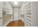 Walk-in closet with custom shelving and hardwood floors, providing ample storage space at 1827 N Grant St # 502, Denver, CO 80203