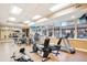 Well-equipped gym featuring treadmills, stationary bikes, and large windows overlooking the neighborhood at 1827 N Grant St # 502, Denver, CO 80203