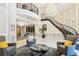 Open lobby with spiral staircase, chandelier, fireplace, comfortable seating area, and elevator access at 1827 N Grant St # 502, Denver, CO 80203