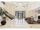 Grand lobby with elegant chandelier, staircase, fireplace, marble floors and comfortable seating area at 1827 N Grant St # 502, Denver, CO 80203