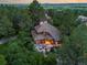 An aerial view of a gorgeous home nestled in lush greenery with a unique roof design and picturesque setting at 4406 Orofino Pl, Castle Rock, CO 80108