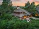 Stunning home with a unique roof design, surrounded by lush greenery, showcasing elegance and natural beauty at 4406 Orofino Pl, Castle Rock, CO 80108