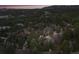 Breathtaking aerial perspective of an upscale residential area with verdant trees and stately homes against a distant mountain range at 4406 Orofino Pl, Castle Rock, CO 80108