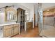 Bathroom showcases double vanities, a glass shower, and warm tile floors at 4406 Orofino Pl, Castle Rock, CO 80108