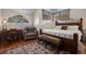 Bedroom boasts a unique window, chair, and dark wood accents at 4406 Orofino Pl, Castle Rock, CO 80108