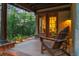 Cozy covered patio with wooden chairs, brick accents, and views of the green surroundings, ideal for unwinding at 4406 Orofino Pl, Castle Rock, CO 80108