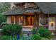 Inviting home entrance with a red front door, decorative columns, and meticulously maintained garden with blue irises at 4406 Orofino Pl, Castle Rock, CO 80108