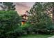 Attractive home nestled among mature trees, with a glimpse of the roof and upper floors, blending with nature at 4406 Orofino Pl, Castle Rock, CO 80108