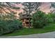 Charming exterior of a multi-story home surrounded by mature trees and a well-manicured lawn in a serene setting at 4406 Orofino Pl, Castle Rock, CO 80108
