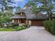 Charming front exterior featuring a unique roof, lush landscaping, and a two-car garage at 4406 Orofino Pl, Castle Rock, CO 80108