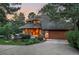 Stunning front exterior at dusk, showcasing the home's unique architectural details and landscape lighting at 4406 Orofino Pl, Castle Rock, CO 80108