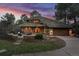 Stunning home exterior with unique roof design, landscaped yard, and charming stone accents create inviting curb appeal at 4406 Orofino Pl, Castle Rock, CO 80108