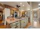 A gourmet kitchen featuring granite countertops, a gas cooktop, and a brick accent wall at 4406 Orofino Pl, Castle Rock, CO 80108