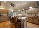Spacious kitchen featuring stainless steel appliances, an island cooktop, and hardwood flooring at 4406 Orofino Pl, Castle Rock, CO 80108