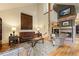 Spacious living room with comfortable leather furniture, a brick fireplace, and stylish decor, creating a welcoming atmosphere at 4406 Orofino Pl, Castle Rock, CO 80108