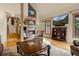 Inviting living room features a brick fireplace, beautiful hardwood floors, and plenty of natural light at 4406 Orofino Pl, Castle Rock, CO 80108