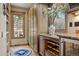 Charming pantry area featuring custom wood cabinets, wine storage, and a view of the backyard at 4406 Orofino Pl, Castle Rock, CO 80108