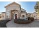 Inviting home featuring a stone-accented entrance, complemented by lush landscaping and a curved walkway at 8300 Fairmount Dr # Rr101, Denver, CO 80247