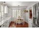 Charming kitchen and breakfast nook with white cabinets and stainless steel appliances at 7255 W 97Th Pl, Broomfield, CO 80021