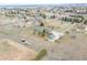 Aerial view of a large property with multiple structures, mature trees, and fenced yard at 12337 2Nd St, Parker, CO 80134