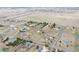 Expansive aerial view showcasing homes, streets, and open grassy areas in a community at 12337 2Nd St, Parker, CO 80134