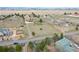 Wide aerial shot showing a community, several homes, and a spacious, grassy lot at 12337 2Nd St, Parker, CO 80134