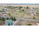 Aerial view of a large grassy property with a green house, mature trees, and outbuildings at 12337 2Nd St, Parker, CO 80134