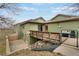View of the backyard with a wooden deck, steel staircase, gas grill and covered patio area at 12337 2Nd St, Parker, CO 80134