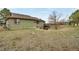 Rear view of the home with a sloped backyard and mature trees at 12337 2Nd St, Parker, CO 80134