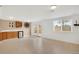 A large basement features tile floors, white walls, and a kitchenette at 12337 2Nd St, Parker, CO 80134