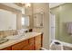 Bathroom featuring a vanity with a sink and a walk-in shower at 12337 2Nd St, Parker, CO 80134