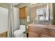 This bathroom features a shower and tub combo and wooden vanity with storage at 12337 2Nd St, Parker, CO 80134