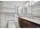 This bathroom has a dark wood vanity with storage and modern mirror and lighting at 12337 2Nd St, Parker, CO 80134