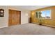 Sunny bedroom with hardwood closet doors and a large window providing ample natural light at 12337 2Nd St, Parker, CO 80134