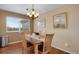 Well-lit dining area featuring hardwood floors, large windows, and a chandelier at 12337 2Nd St, Parker, CO 80134