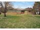Charming ranch-style home with green siding and brick accents, set on a spacious lawn at 12337 2Nd St, Parker, CO 80134